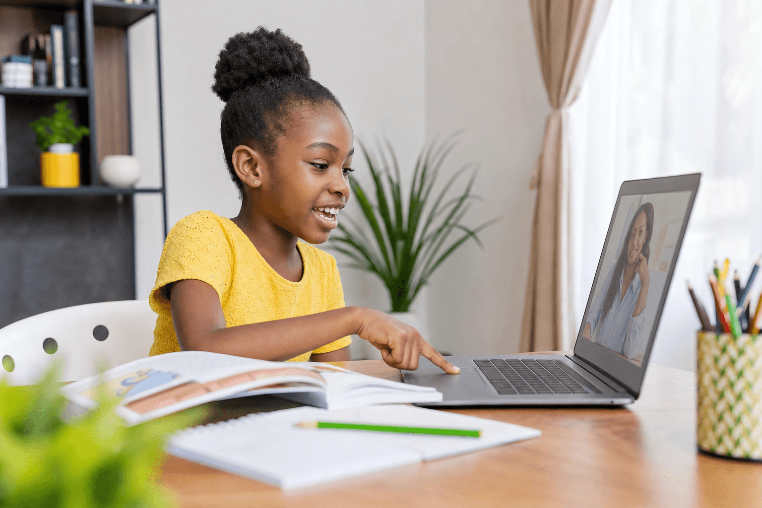 A child enjoying a one-to-one online literacy lesson